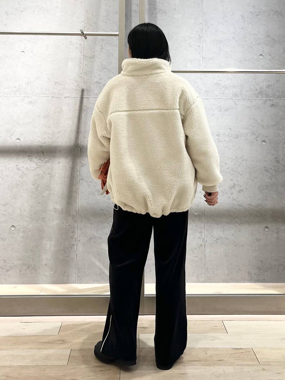 ブラック系のブーツ、ホワイト系のニット/セーター、ホワイト系のその他アウターを着用したレディースの冬コーディネートの7枚目の写真