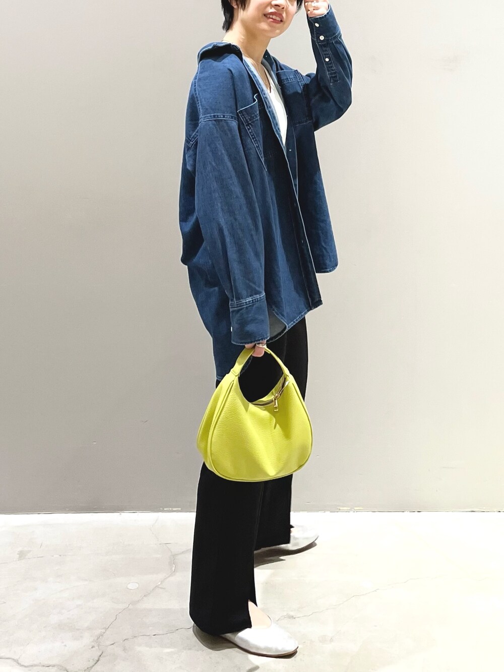 イエロー系のショルダーバッグ、ブラック系のその他パンツ、グレー系のパンプスを着用したレディースの春コーディネートの2枚目の写真