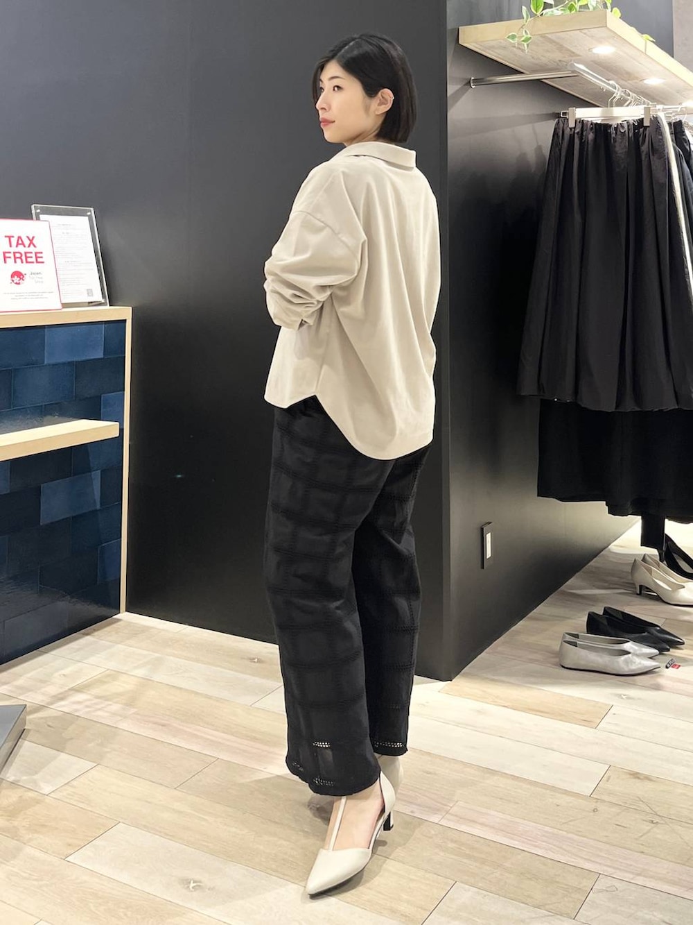 ホワイト系のパンプス、ホワイト系のショルダーバッグ、ベージュ系のシャツ/ブラウスを着用したレディースの冬コーディネートの3枚目の写真