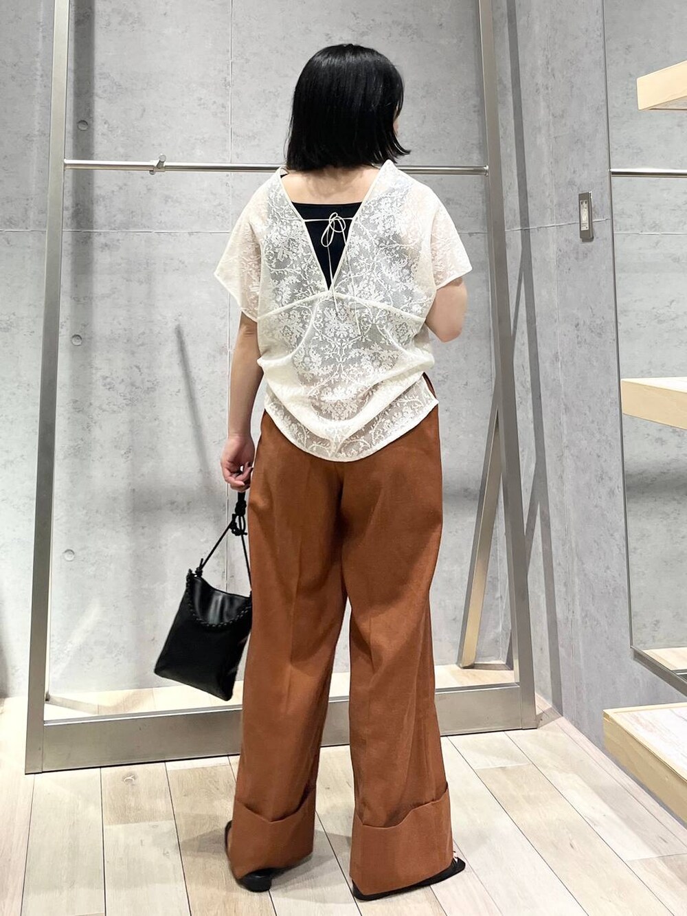 ブラック系のタンクトップ、ブラック系のサンダル、ブラック系のショルダーバッグを着用したレディースの夏コーディネートの4枚目の写真