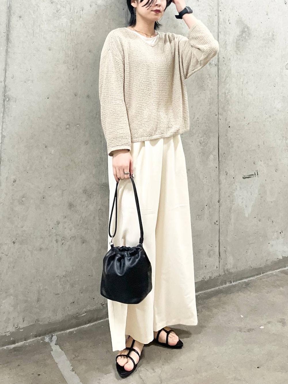 ブラック系のショルダーバッグ、ブラック系のサンダル、ホワイト系のTシャツ/カットソーを着用したレディースの春コーディネートの2枚目の写真
