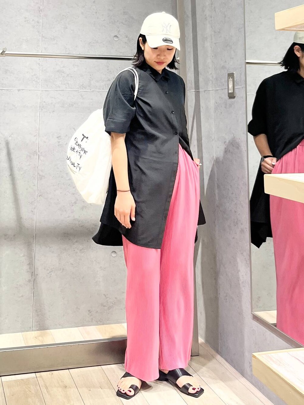 グレー系のチュニック、ピンク系のその他パンツ、ホワイト系のショルダーバッグを着用したレディースの夏コーディネートの2枚目の写真