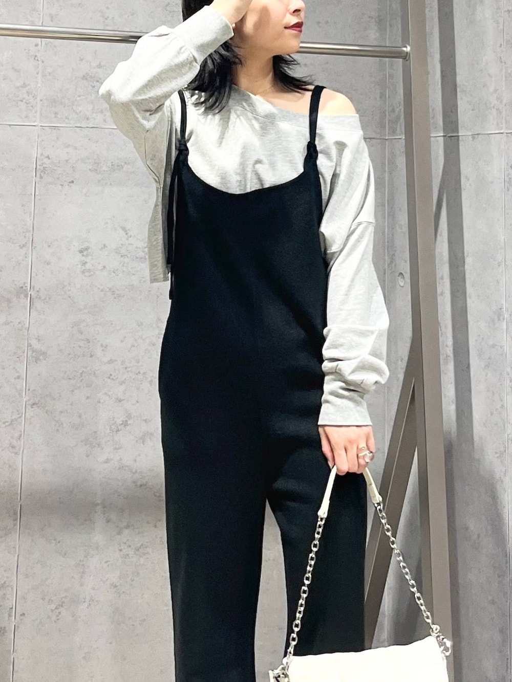 ホワイト系のショルダーバッグ、シルバー系のパンプス、グレー系のスウェットを着用したレディースの秋コーディネートの5枚目の写真