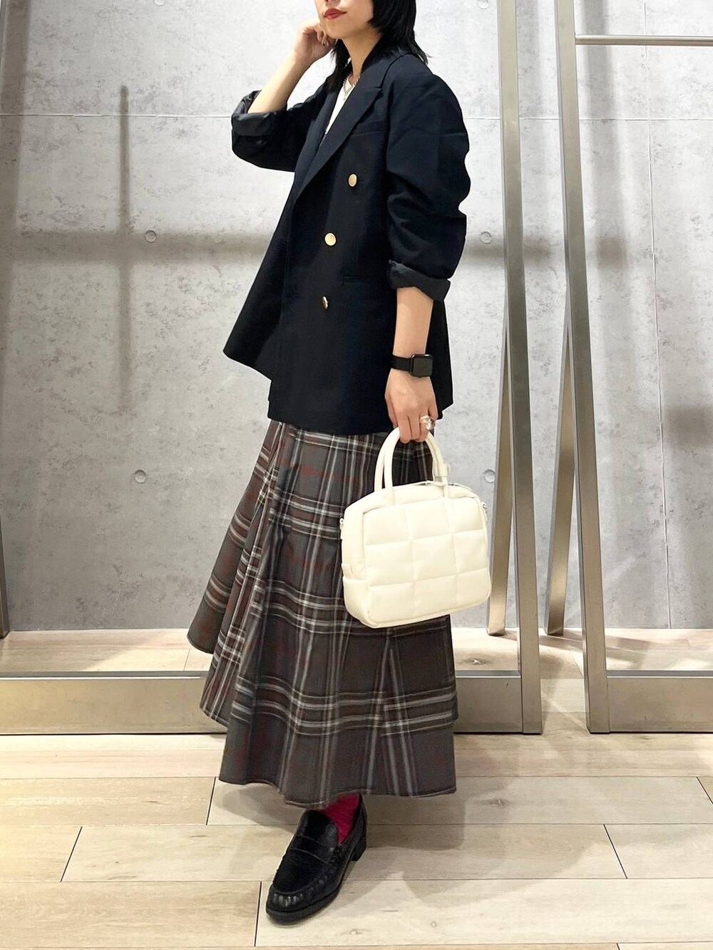ブルー系のテーラードジャケット、ホワイト系のボストンバッグ、ブラック系のローファーを着用したレディースの秋コーディネートの3枚目の写真