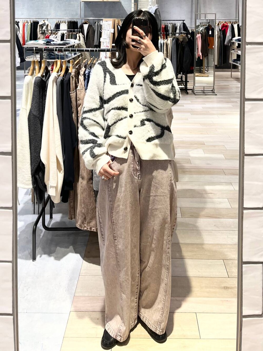 ホワイト系のカーディガン/ボレロ、ブラック系のローファー、ブラック系のショルダーバッグを着用したレディースの冬コーディネートの4枚目の写真