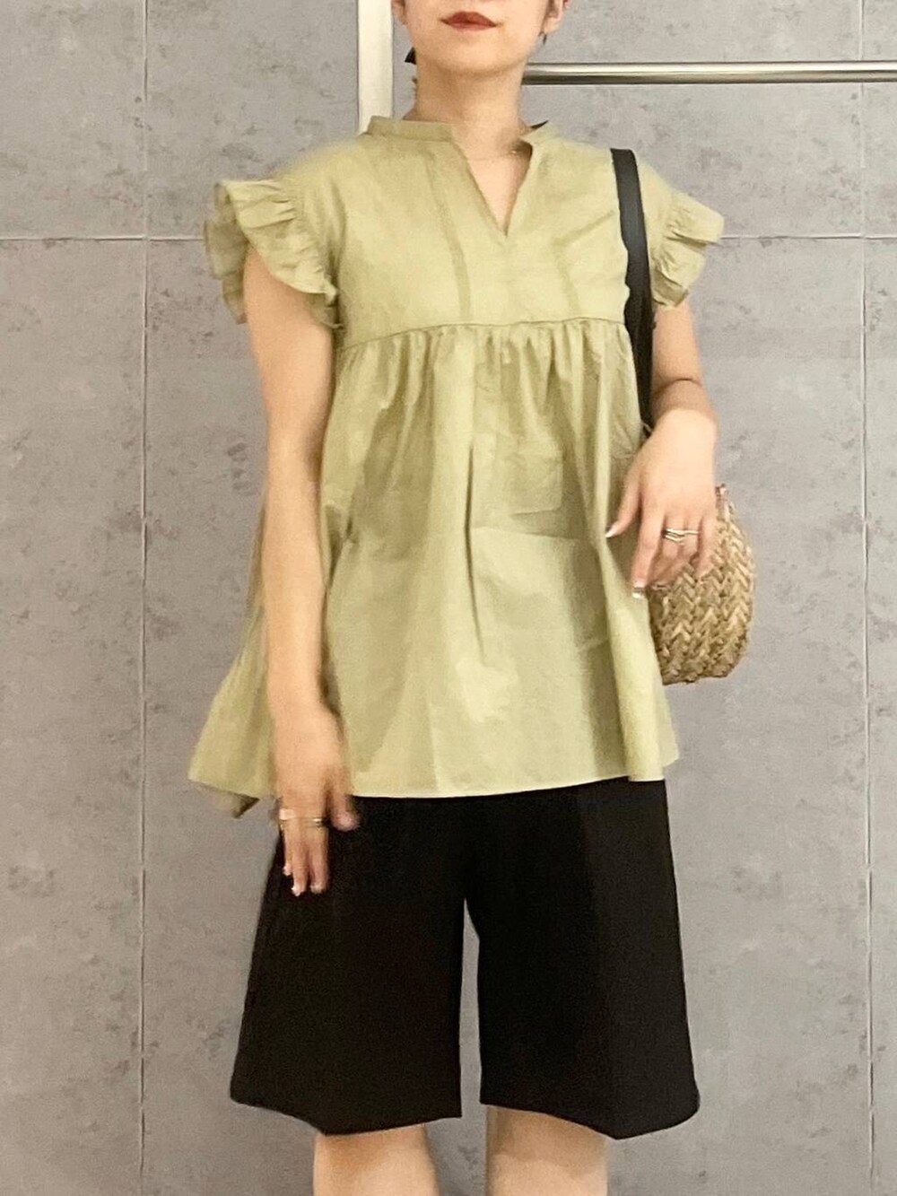 ブラック系のショルダーバッグ、ブラウン系のサンダル、ブラック系のその他パンツを着用したレディースの夏コーディネートの4枚目の写真