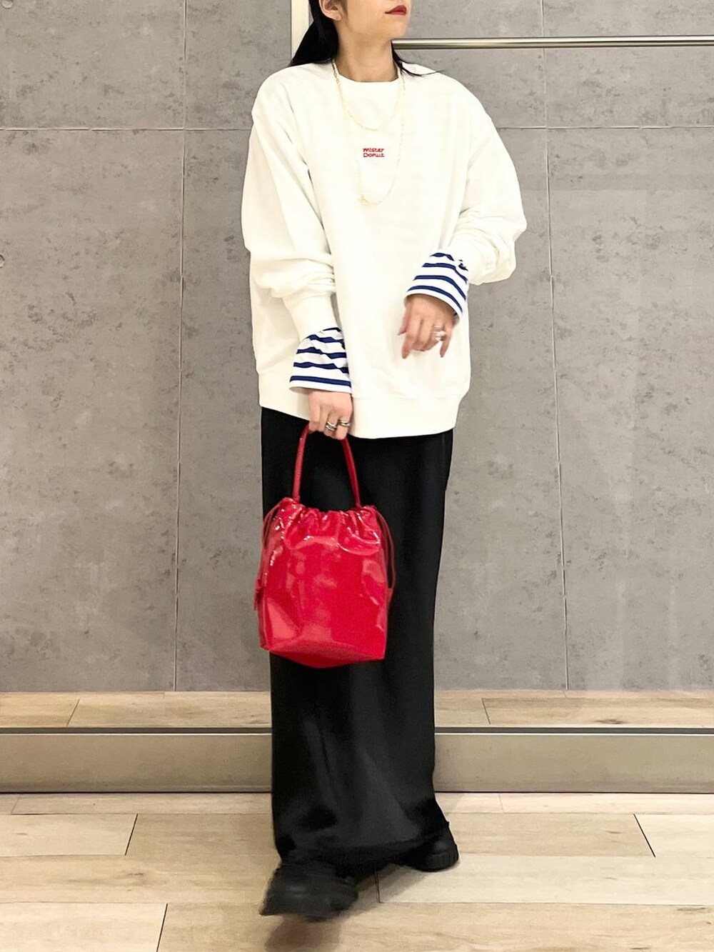 ブラック系のスカート、ブラック系のスニーカー、ホワイト系のスウェットを着用したレディースの冬コーディネートの5枚目の写真