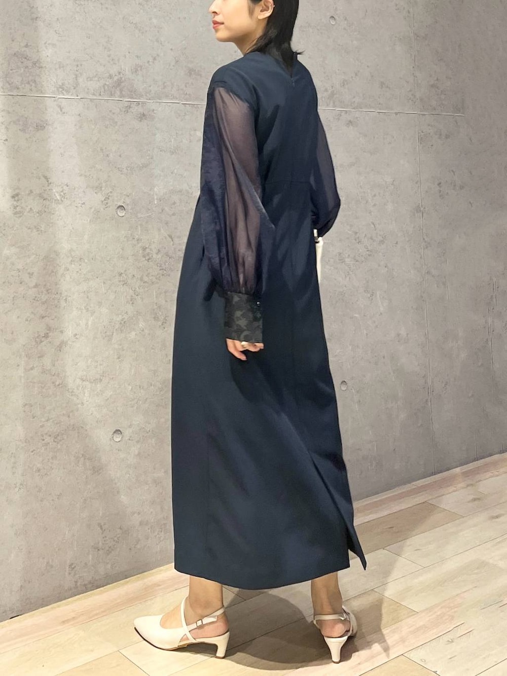 ホワイト系のショルダーバッグ、ホワイト系のパンプス、ブルー系のドレスを着用したレディースの夏コーディネートの3枚目の写真