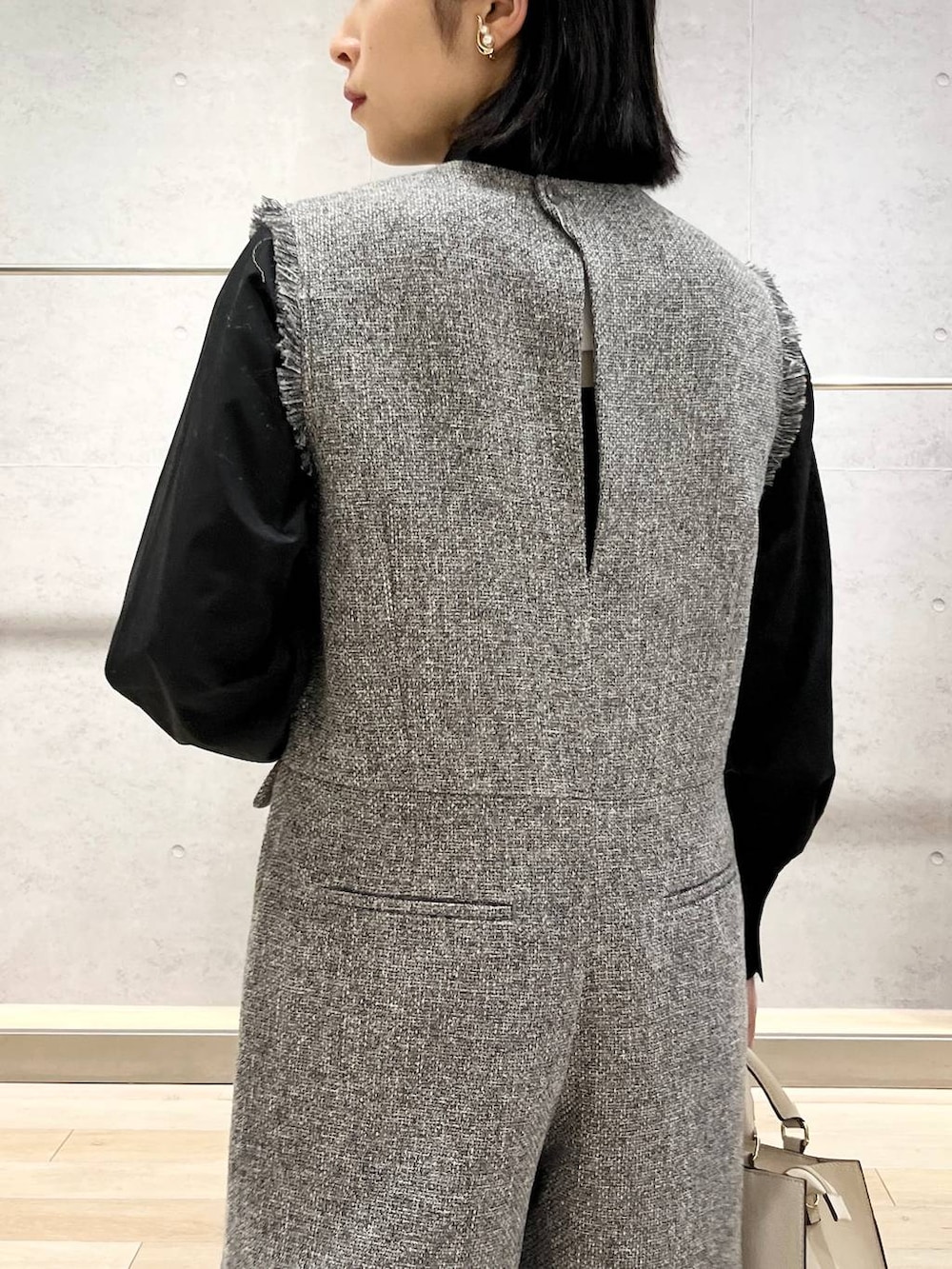 ブラック系のパンプス、ホワイト系のサロペット/オーバーオール、ブラック系のシャツ/ブラウスを着用したレディースの冬コーディネートの4枚目の写真