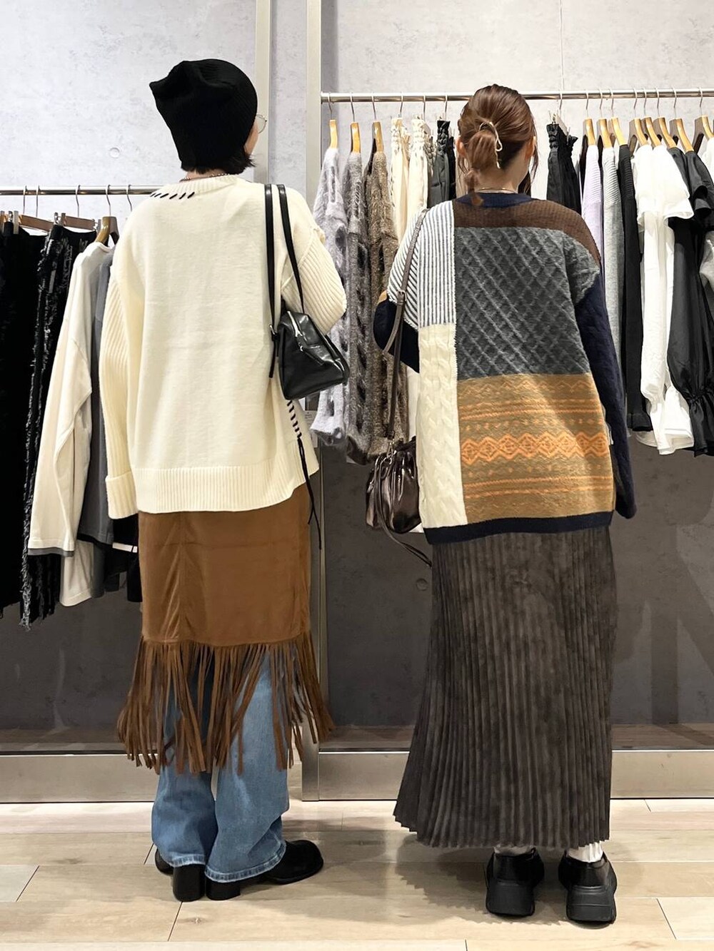 ブルー系のデニムパンツ、ブラック系のその他シューズ、グレー系のスカートを着用したレディースの秋コーディネートの3枚目の写真