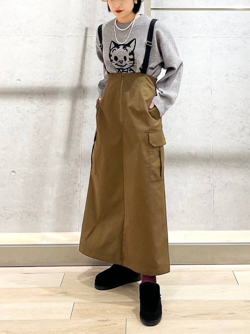 ブラック系のモカシン/デッキシューズ、ブラウン系のスカート、グレー系のニット/セーターを着用したレディースの冬コーディネートの7枚目の写真