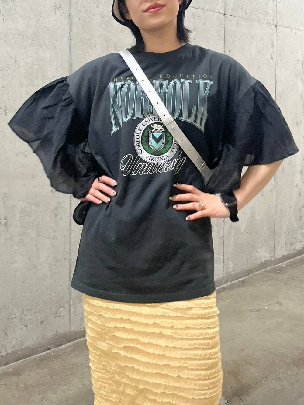 ベージュ系のスカート、シルバー系のショルダーバッグ、ホワイト系のサンダルを着用したレディースの春コーディネートの2枚目の写真