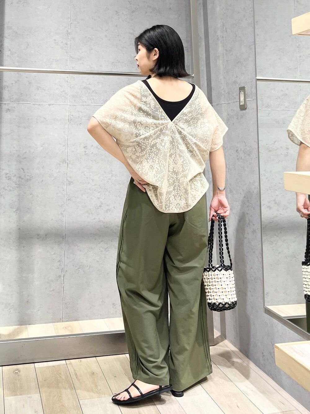 ブラック系のタンクトップ、ブラック系のサンダル、グリーン系のその他パンツを着用したレディースの夏コーディネートの3枚目の写真