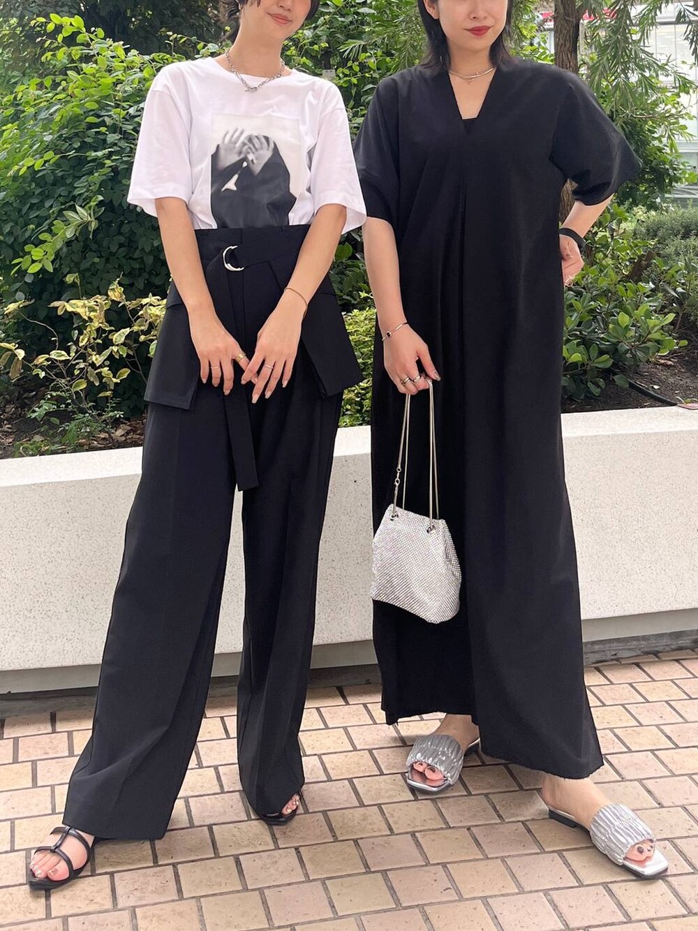 シルバー系のショルダーバッグ、ブラック系のサンダル、ブラック系のワンピースを着用したレディースの夏コーディネートの7枚目の写真