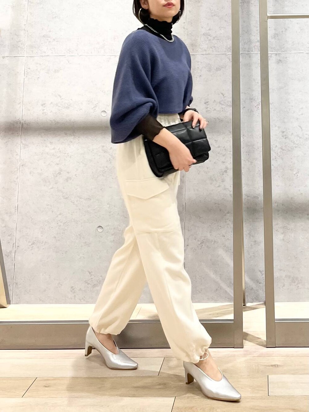 ブルー系のワンピース、ブラック系のTシャツ/カットソー、ブラック系のショルダーバッグを着用したレディースの秋コーディネートの7枚目の写真