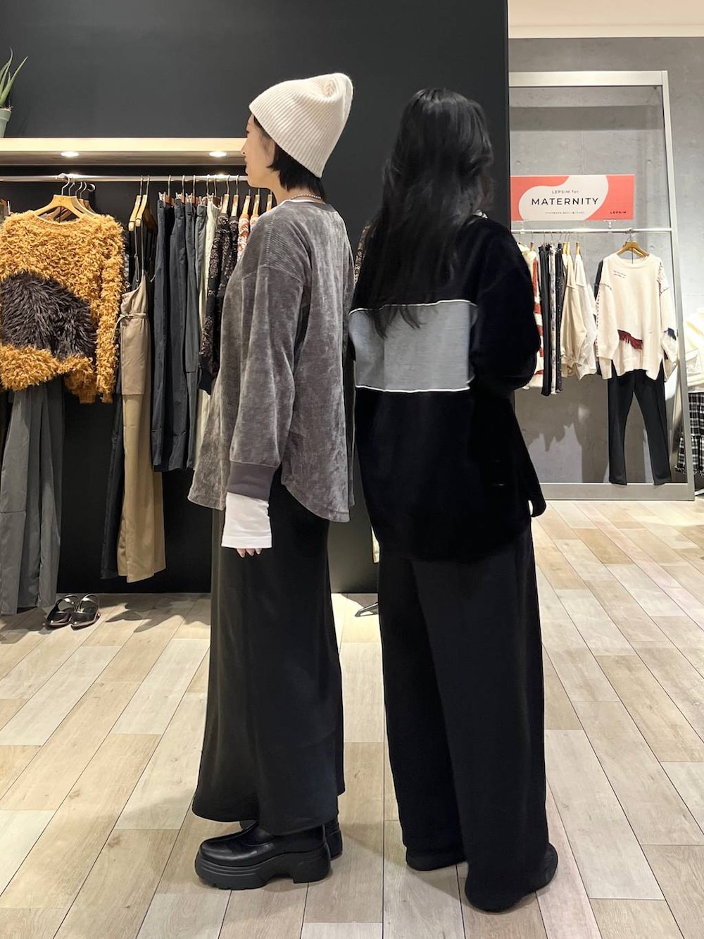 ブラック系のスカート、ブラック系のスウェットパンツ、ブラック系のブーツを着用したレディースの冬コーディネートの4枚目の写真