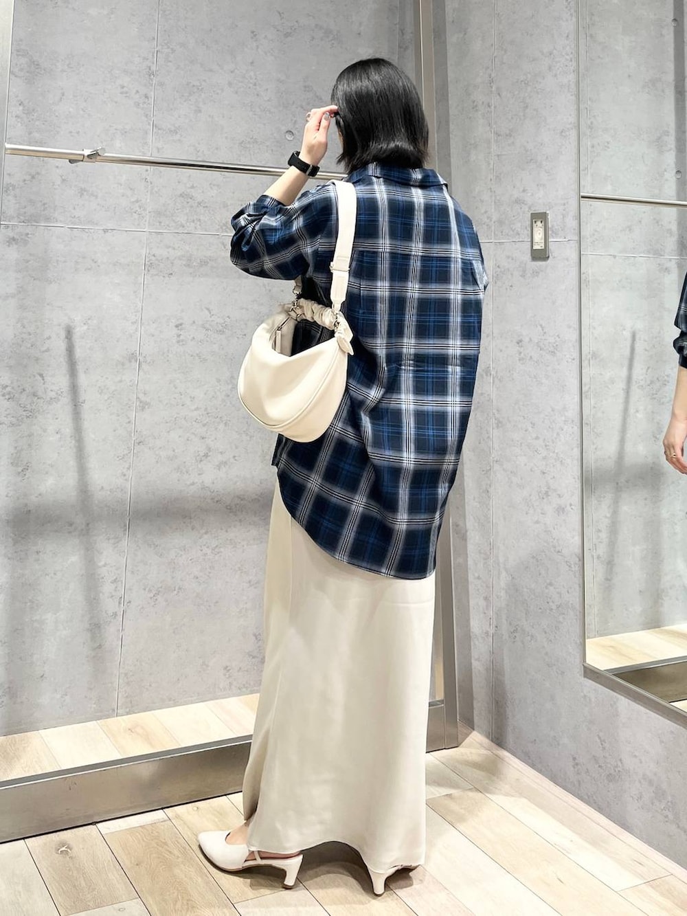 ホワイト系のショルダーバッグ、ホワイト系のスカート、ブルー系のシャツ/ブラウスを着用したレディースの冬コーディネートの8枚目の写真