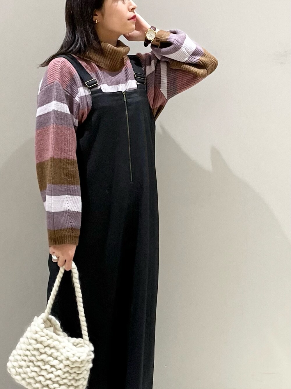 ピンク系のニット/セーター、ホワイト系のバッグ、ホワイト系のスニーカーを着用したレディースの秋コーディネートの3枚目の写真