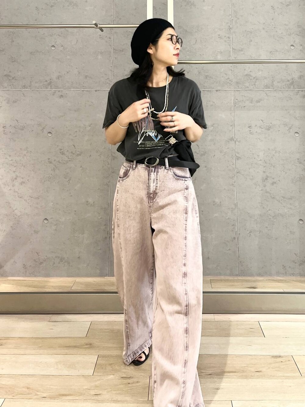 パープル系のデニムパンツ、ブラック系のショルダーバッグ、ブラック系のTシャツ/カットソーを着用したレディースの春コーディネートの3枚目の写真