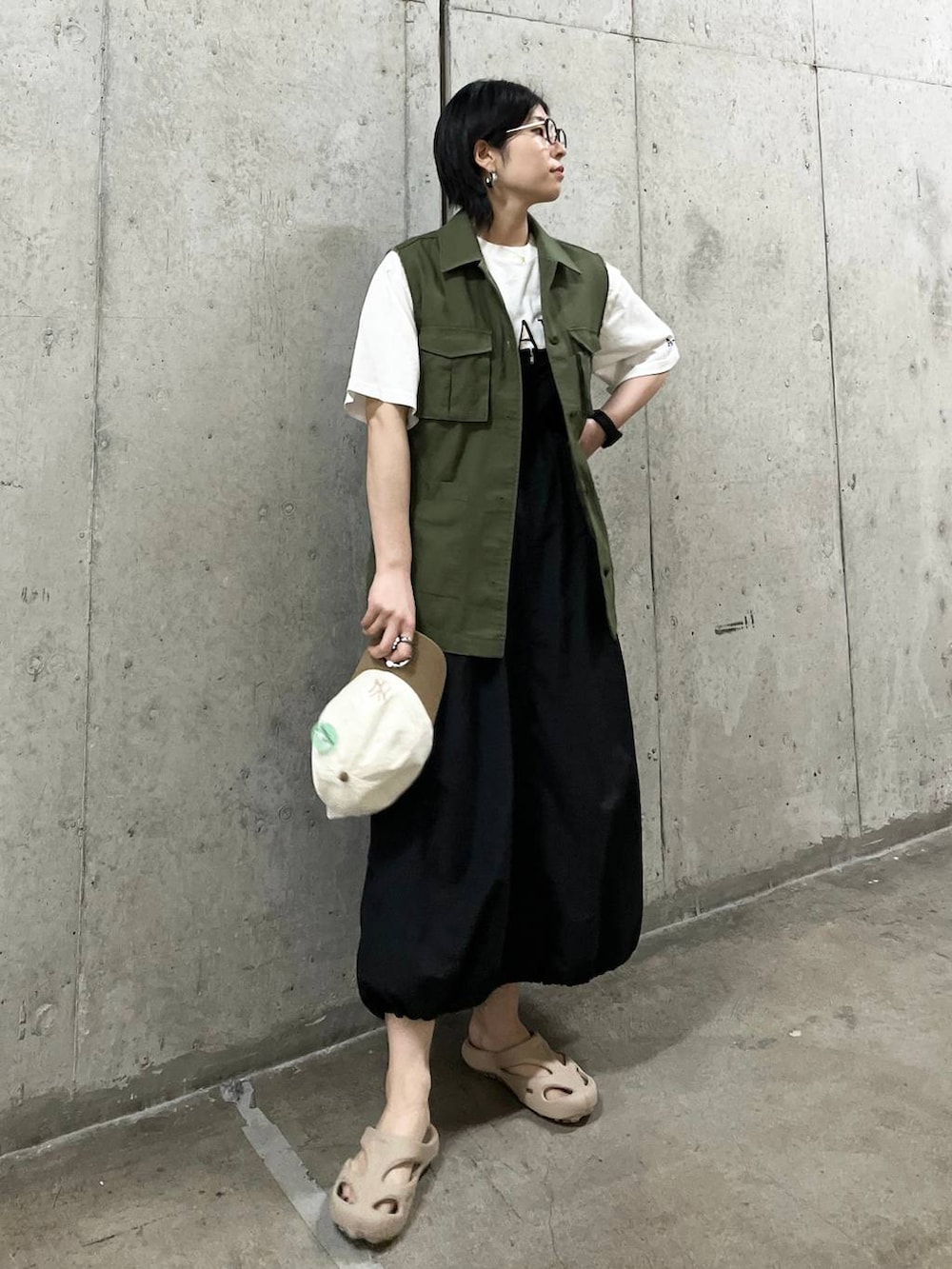 ブラック系のワンピース、グリーン系のマタニティウェア/グッズ、グリーン系のキャップを着用したレディースの春コーディネートの2枚目の写真