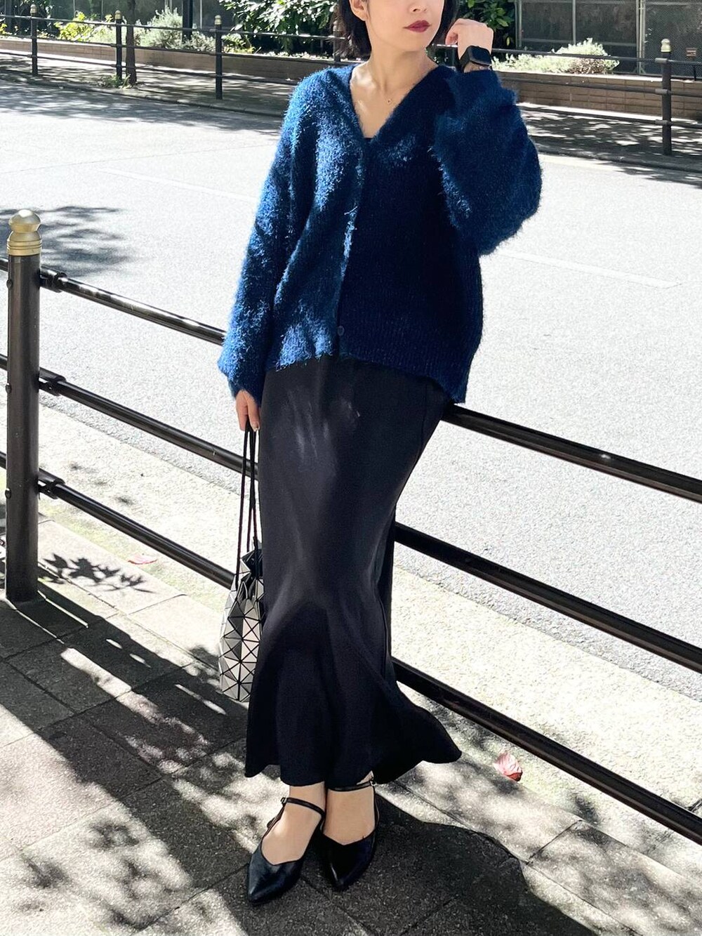 ブラック系のその他シューズ、ブラック系のスカート、ブルー系のニット/セーターを着用したレディースの秋コーディネートの6枚目の写真