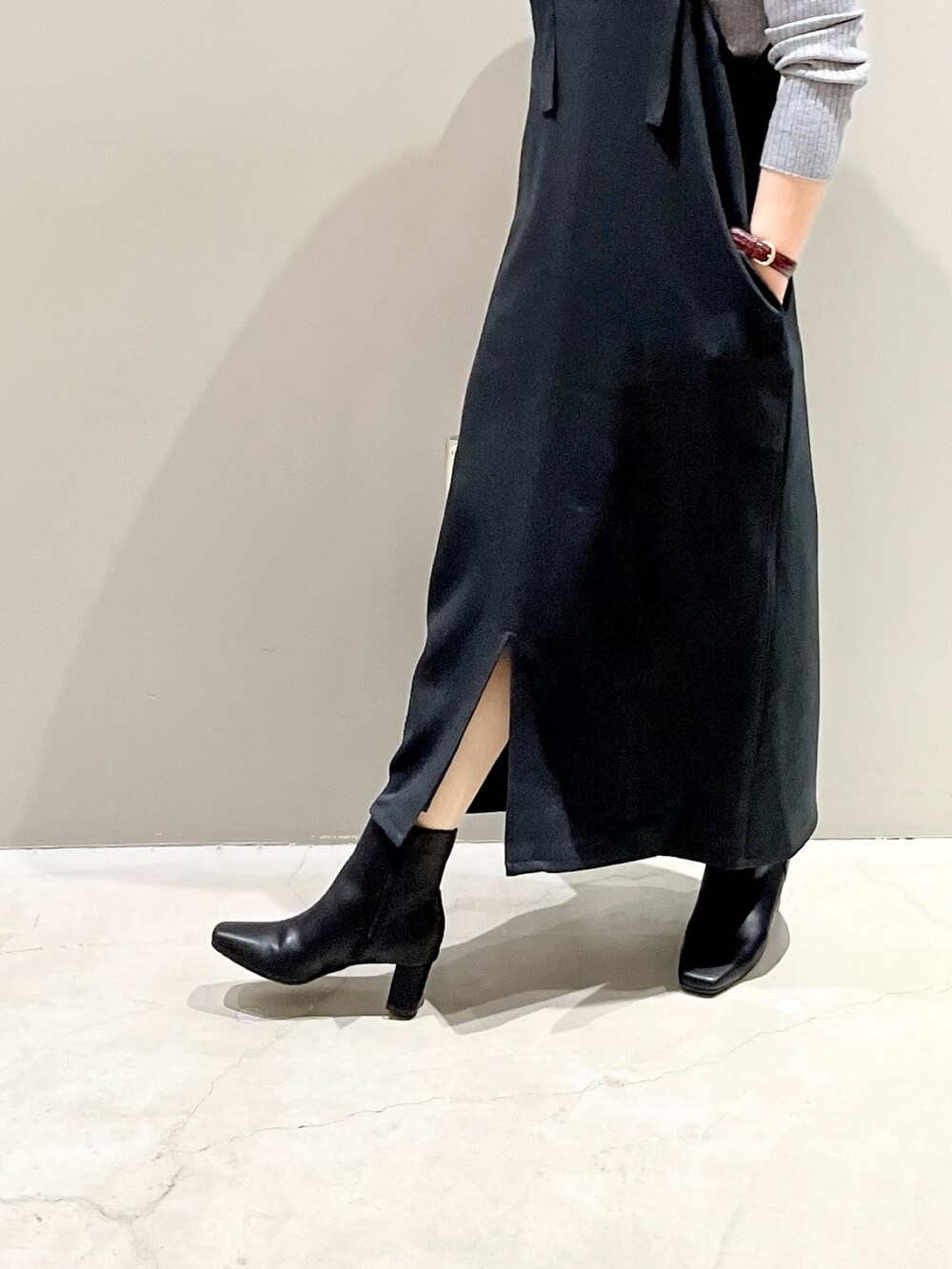 ブラック系のワンピース/ドレス、グレー系のニット/セーター、ホワイト系のショルダーバッグを着用したレディースの秋コーディネートの3枚目の写真