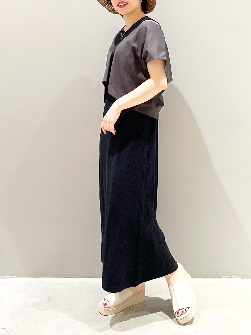 ベージュ系のサンダル、ブラック系のワンピース、ブラウン系のハットを着用したレディースの春コーディネートの7枚目の写真