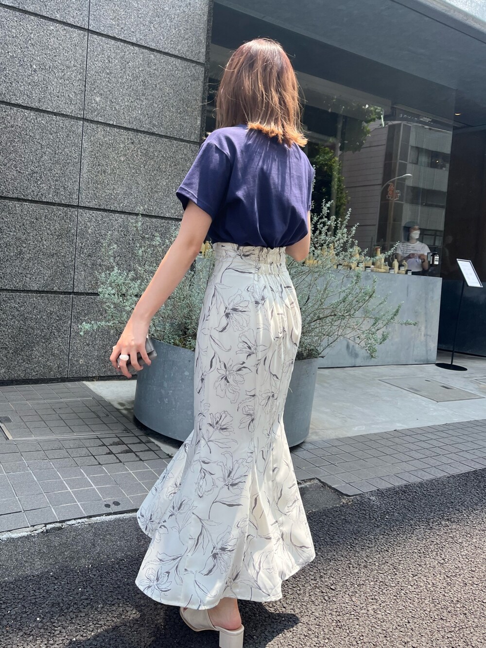 ブルー系のTシャツ/カットソー、ホワイト系のスカート、ホワイト系のサンダルを着用したレディースの夏コーディネートの2枚目の写真