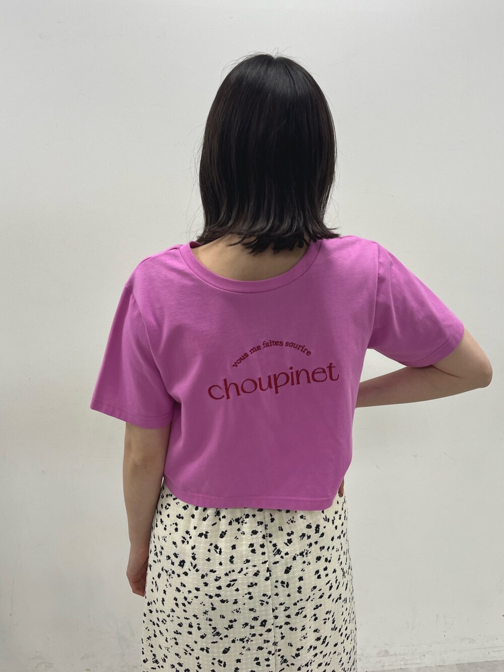 ピンク系のTシャツ/カットソー、ホワイト系のスカート、ホワイト系のサンダルを着用したレディースの春コーディネートの3枚目の写真