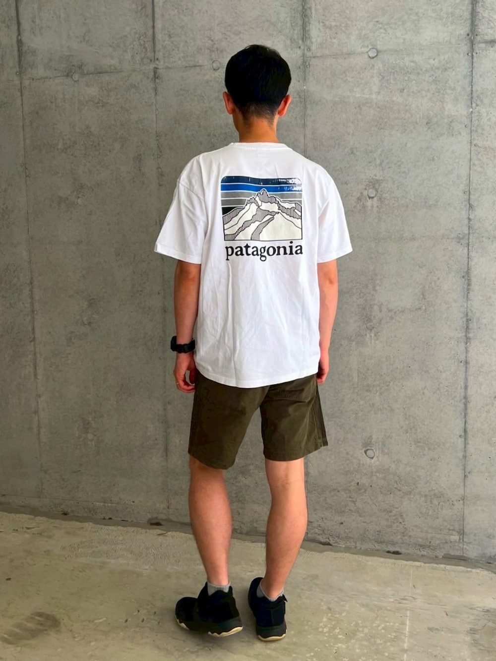 ホワイト系のTシャツ/カットソー、グリーン系のその他パンツ、ブラック系のレインシューズを着用したメンズの夏コーディネートの3枚目の写真