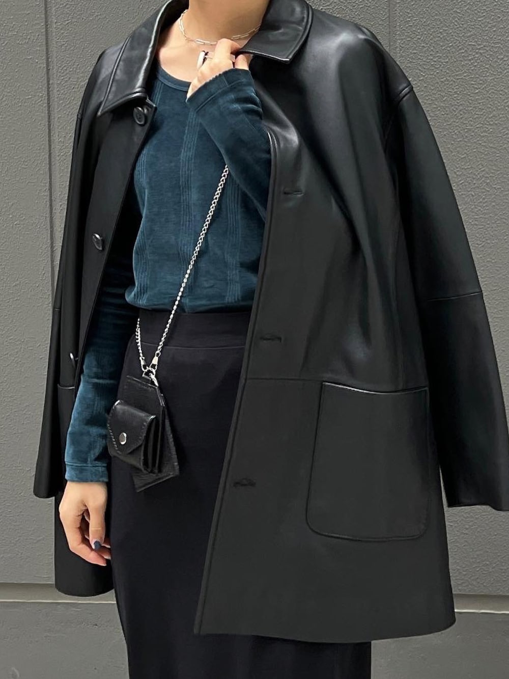 ブラック系のライダースジャケット、グリーン系のTシャツ/カットソー、ブラック系のブーツを着用したレディースの秋コーディネートの5枚目の写真