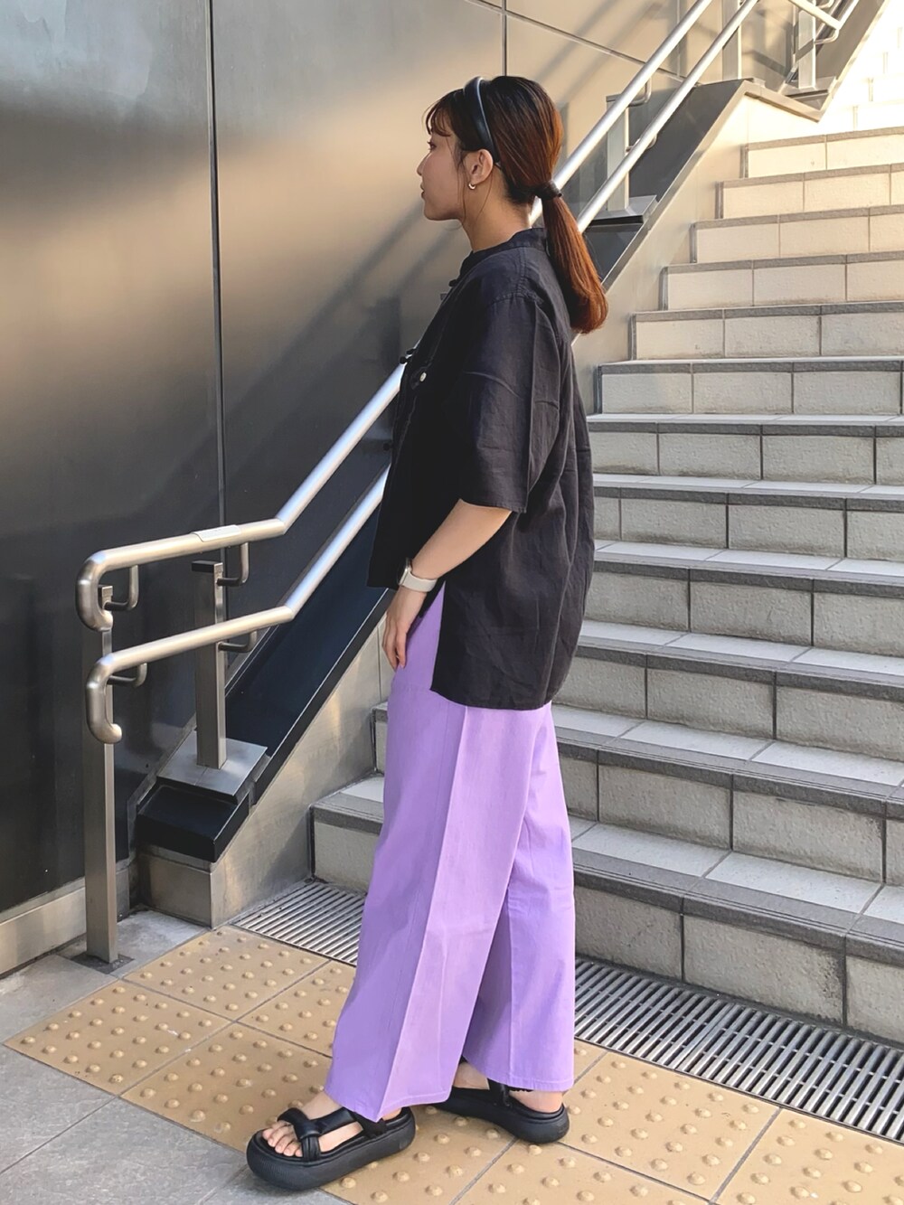 ブラック系のシャツ/ブラウス、ブラック系のTシャツ/カットソー、パープル系のデニムパンツを着用したレディースの夏コーディネートの2枚目の写真