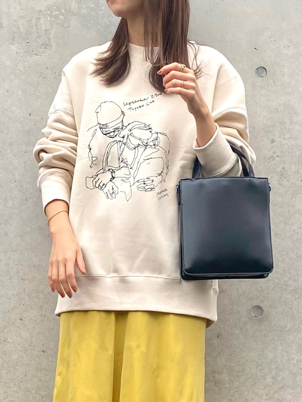 ホワイト系のスウェット、イエロー系のスカート、ブラック系のバレエシューズを着用したレディースの秋コーディネートの3枚目の写真