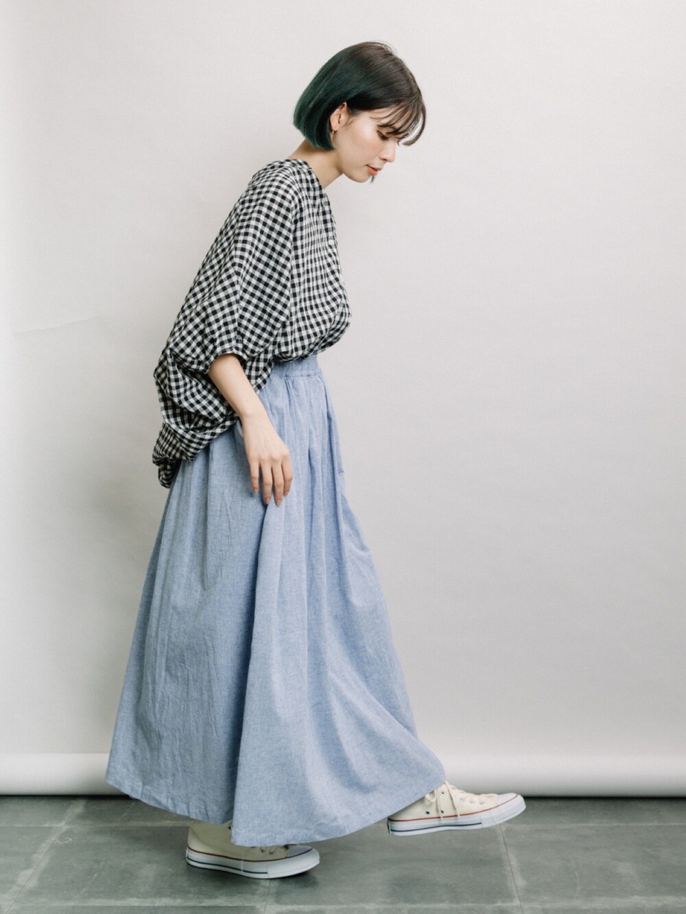 ホワイト系のシャツ/ブラウス、ブルー系のスカート、ホワイト系のスニーカーを着用したレディースの春コーディネートの2枚目の写真