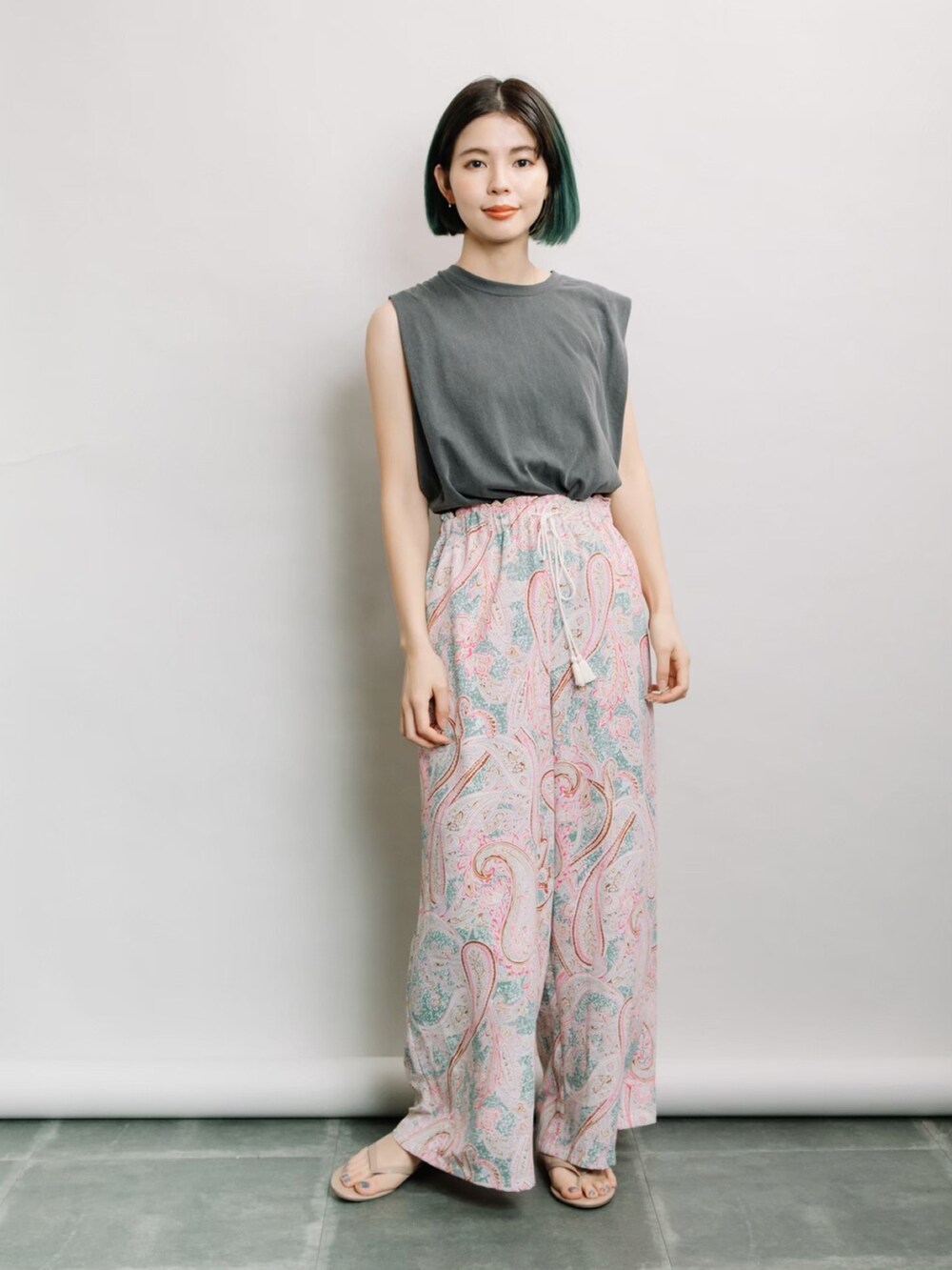 グレー系のタンクトップ、グリーン系のその他パンツを着用したレディースの春コーディネートの2枚目の写真