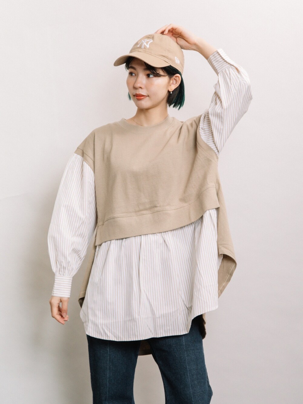 ブラウン系のTシャツ/カットソー、ブルー系のデニムパンツ、グレー系のスニーカーを着用したレディースの冬コーディネートの3枚目の写真