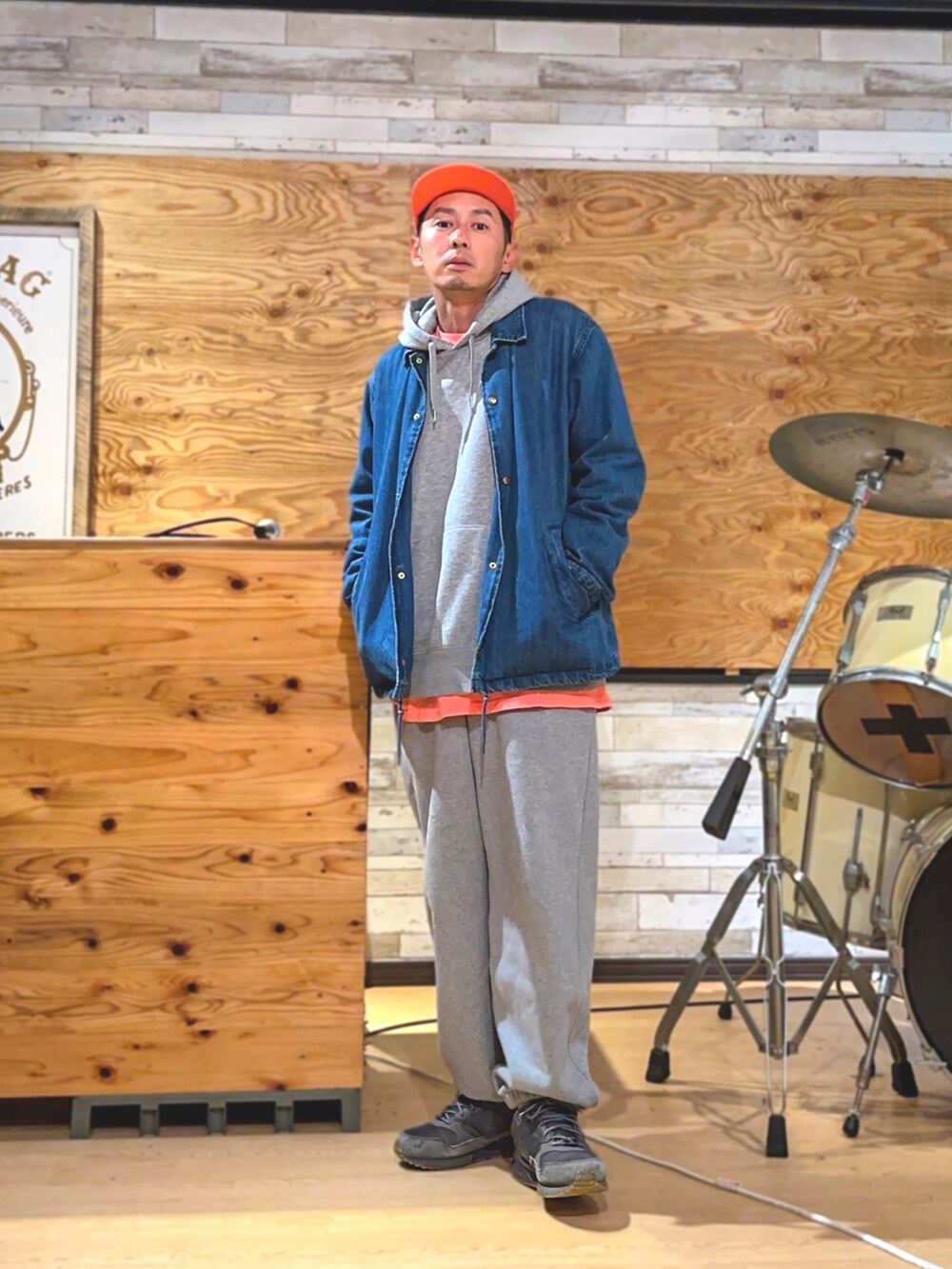 ブルー系のデニムジャケット、グレー系のスウェットパンツ、グレー系のパーカーを着用したメンズの春コーディネートの2枚目の写真