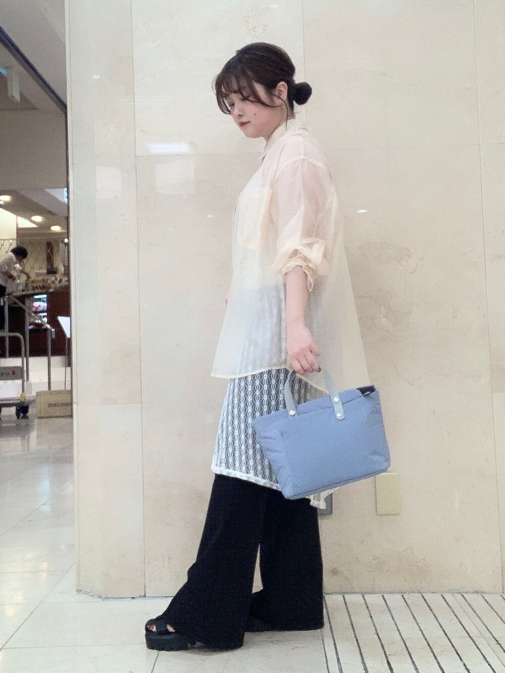 ブルー系のショルダーバッグを着用したレディースの夏コーディネートの2枚目の写真