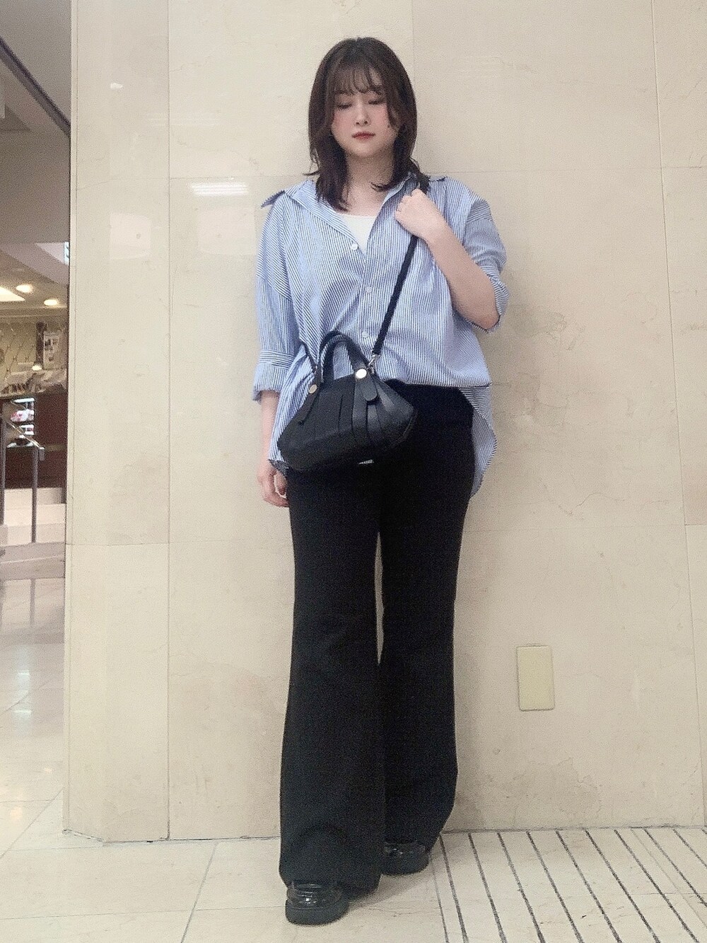 ブラック系のショルダーバッグを着用したレディースの夏コーディネートの3枚目の写真