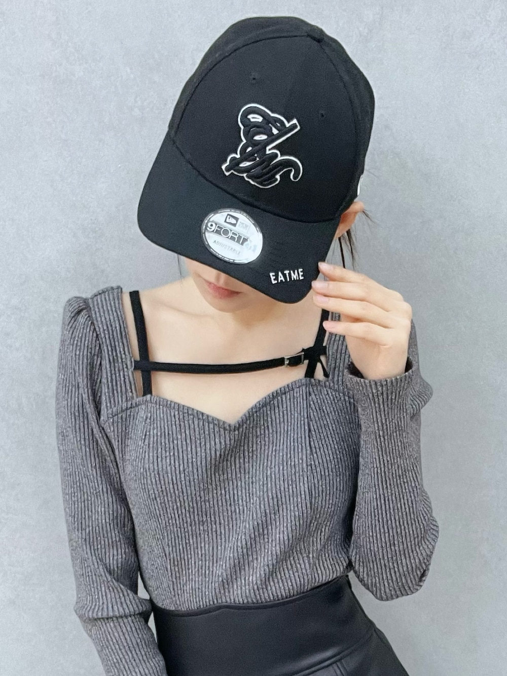 グレー系のTシャツ/カットソー、ブラック系のスカート、ブラック系のブーツを着用したレディースの冬コーディネートの6枚目の写真