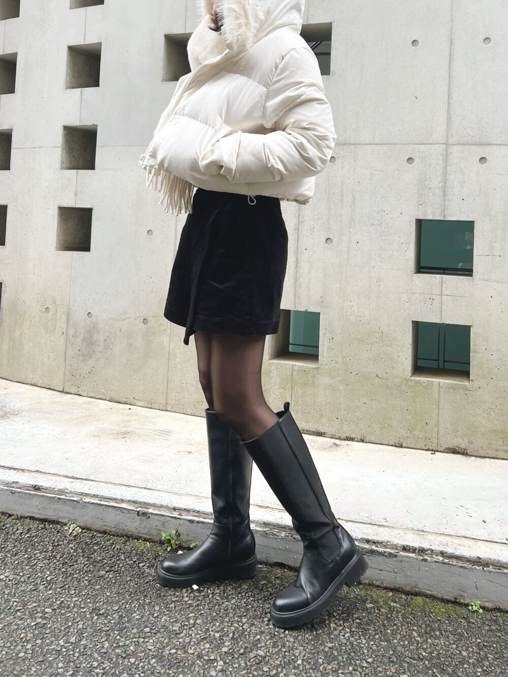 ホワイト系のブルゾン、ホワイト系のマフラーを着用したレディースの冬コーディネートの5枚目の写真