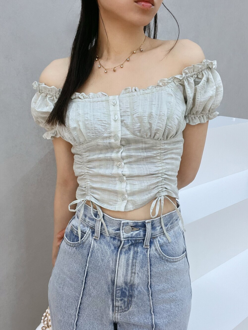 ホワイト系のハンドバッグ、ブルー系のデニムパンツ、グリーン系のシャツ/ブラウスを着用したレディースの夏コーディネートの6枚目の写真