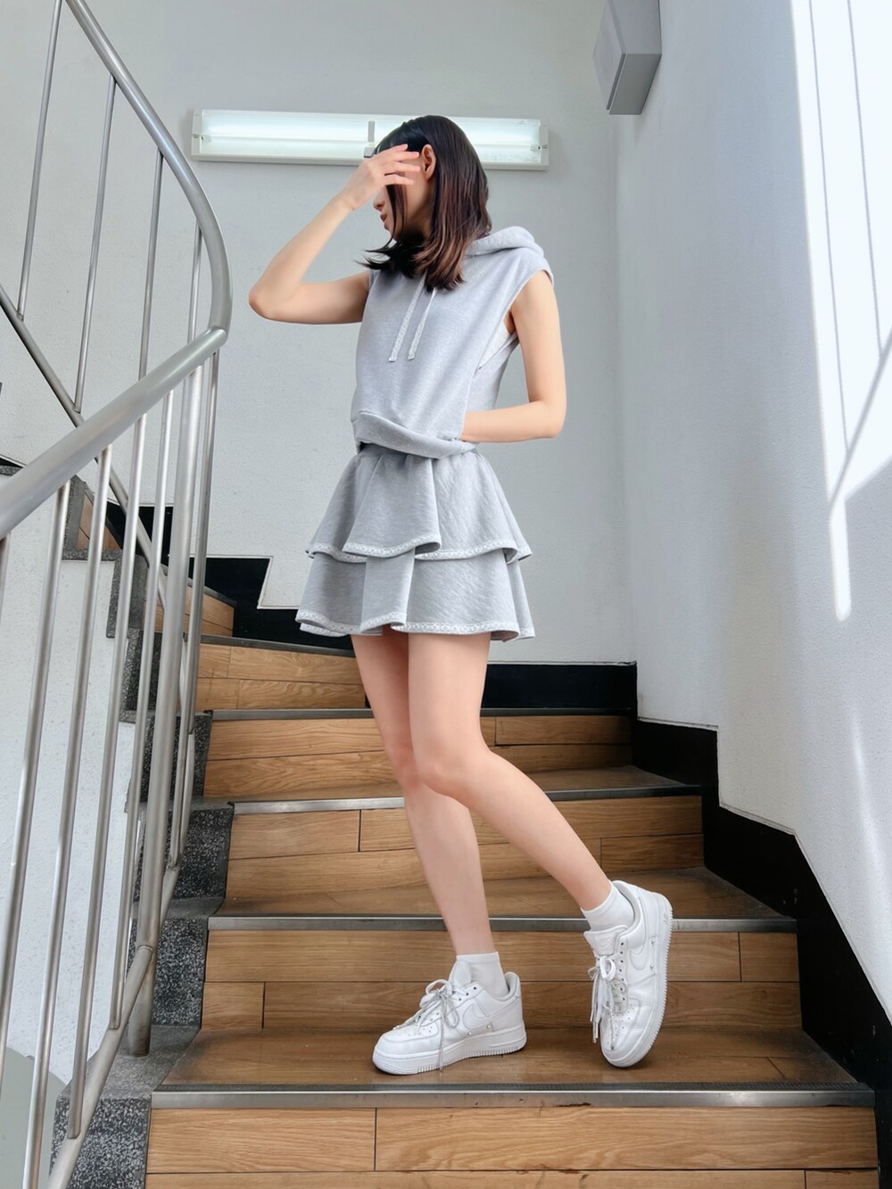 グレー系のワンピース、ホワイト系のキャミソール、グレー系のTシャツ/カットソーを着用したレディースの冬コーディネートの2枚目の写真