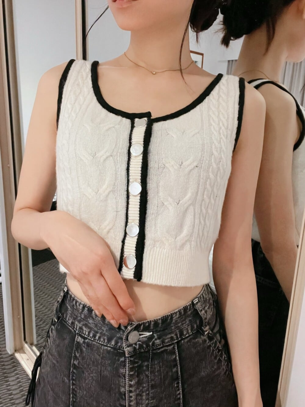 ホワイト系のニット/セーター、ブラック系のデニムパンツ、ゴールド系のネックレスを着用したレディースの秋コーディネートの10枚目の写真