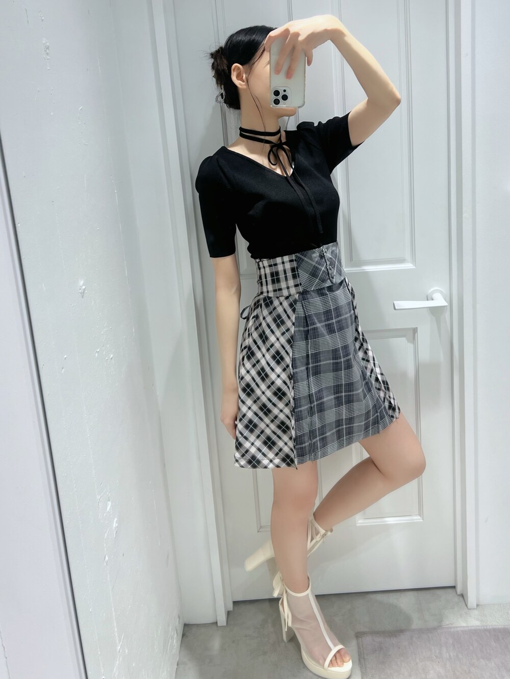 ブラック系のワンピース、ホワイト系のサンダルを着用したレディースの春コーディネートの3枚目の写真