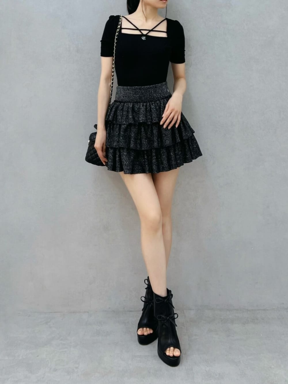 ブラック系のサンダル、ブラック系のスカート、ブラック系のTシャツ/カットソーを着用したレディースの夏コーディネートの4枚目の写真
