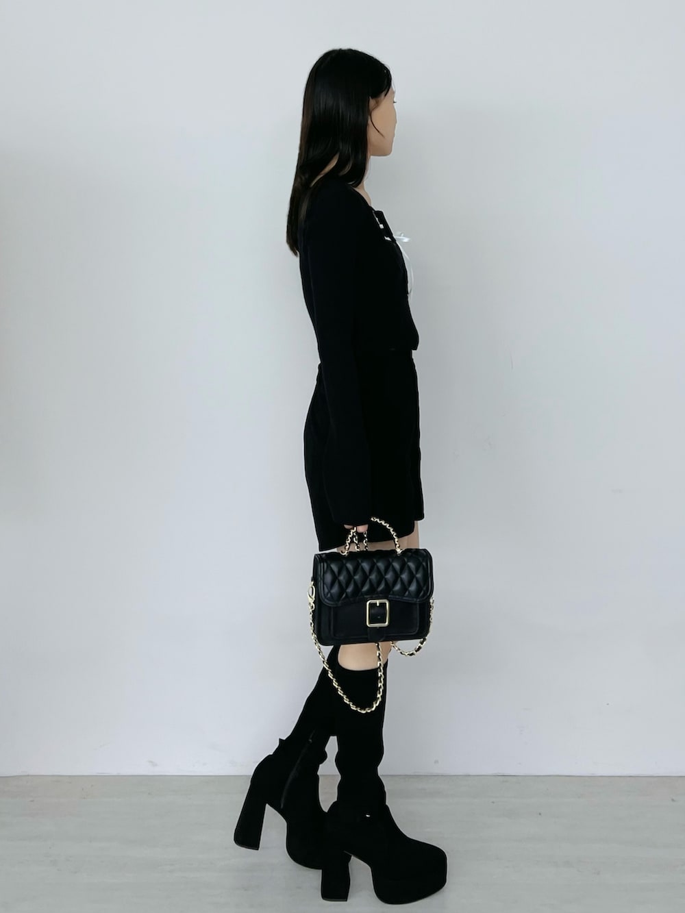 ブラック系のその他パンツ、ブラック系のニット/セーター、ブラック系のブーツを着用したレディースの秋コーディネートの2枚目の写真