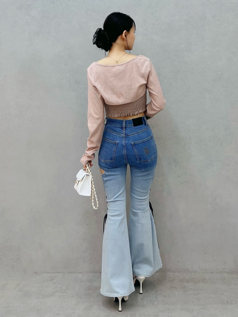 その他のデニムパンツ、ホワイト系のサンダル、ホワイト系のハンドバッグを着用したレディースの春コーディネートの3枚目の写真