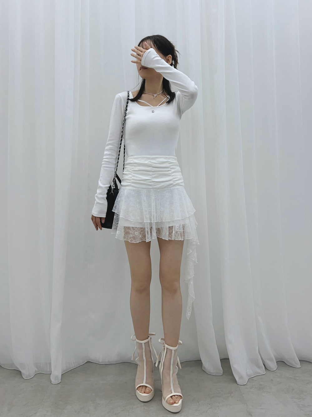 ホワイト系のスカート、ホワイト系のサンダル、ホワイト系のTシャツ/カットソーを着用したレディースの夏コーディネートの7枚目の写真