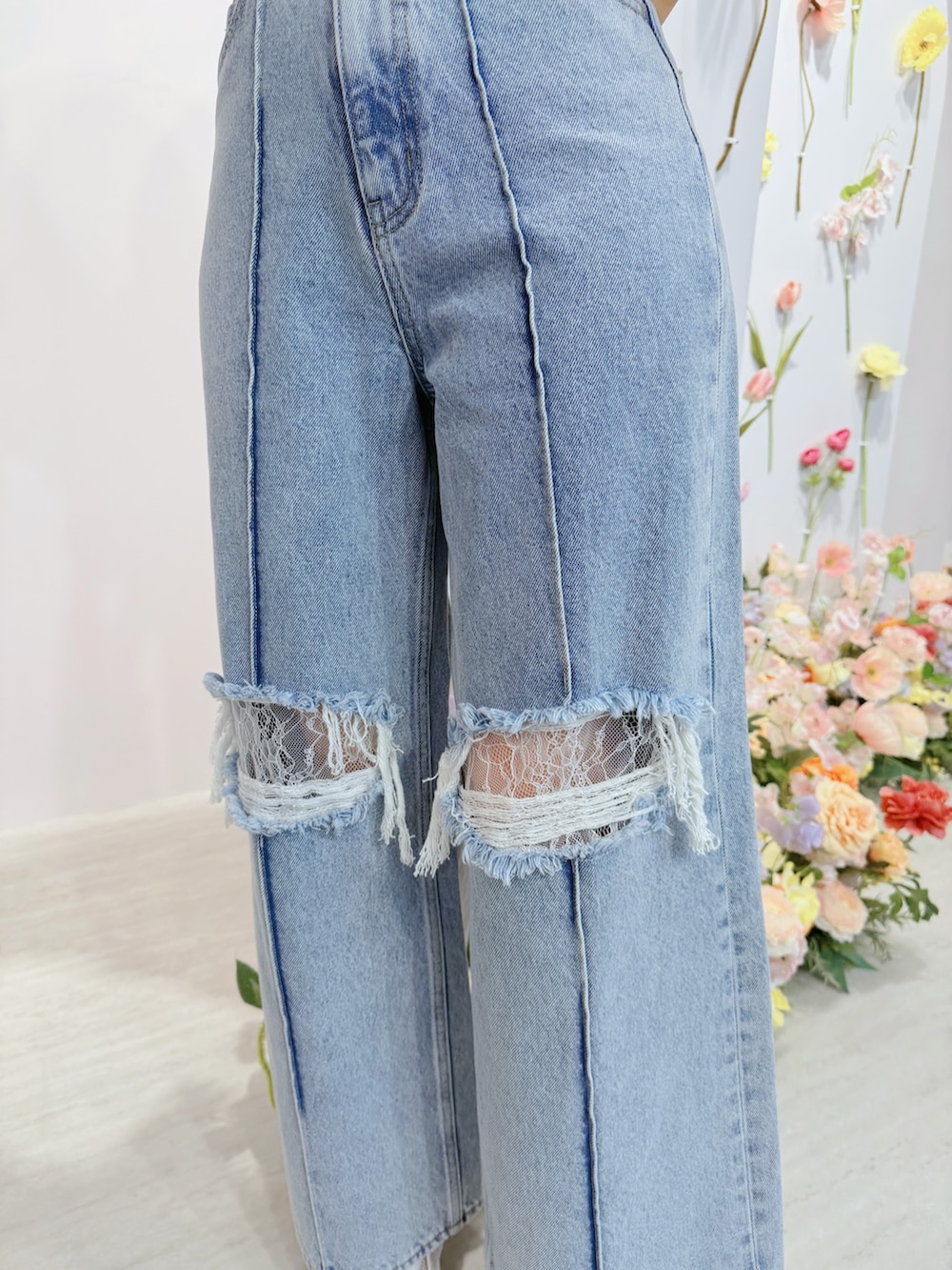 ブルー系のデニムパンツ、オレンジ系のTシャツ/カットソー、ホワイト系のブーツを着用したレディースの春コーディネートの6枚目の写真